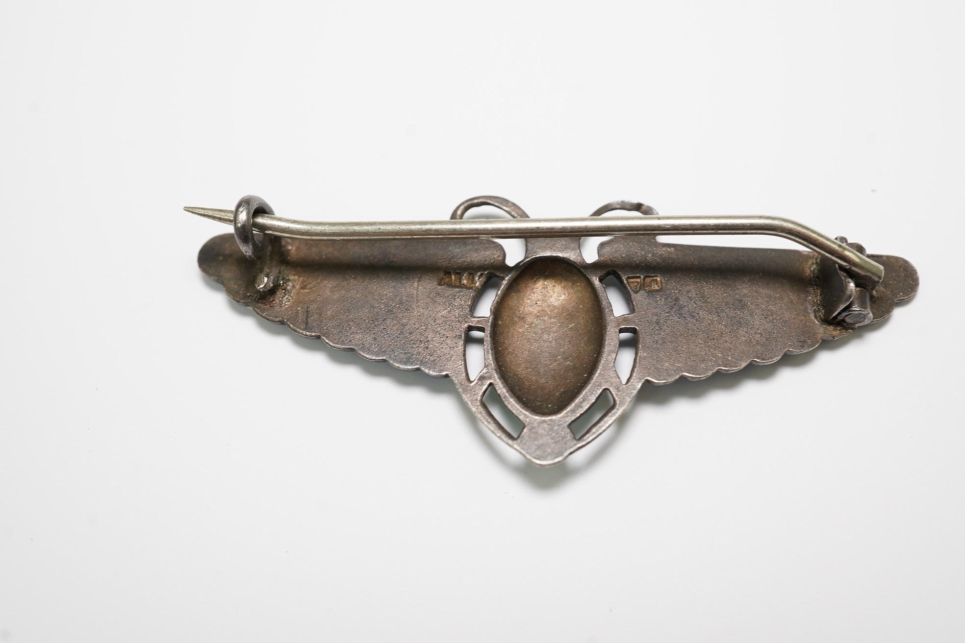 An Egyptian Revival silver and enamelled oval pendant, 88mm and a silver enamelled stylised butterfly brooch.